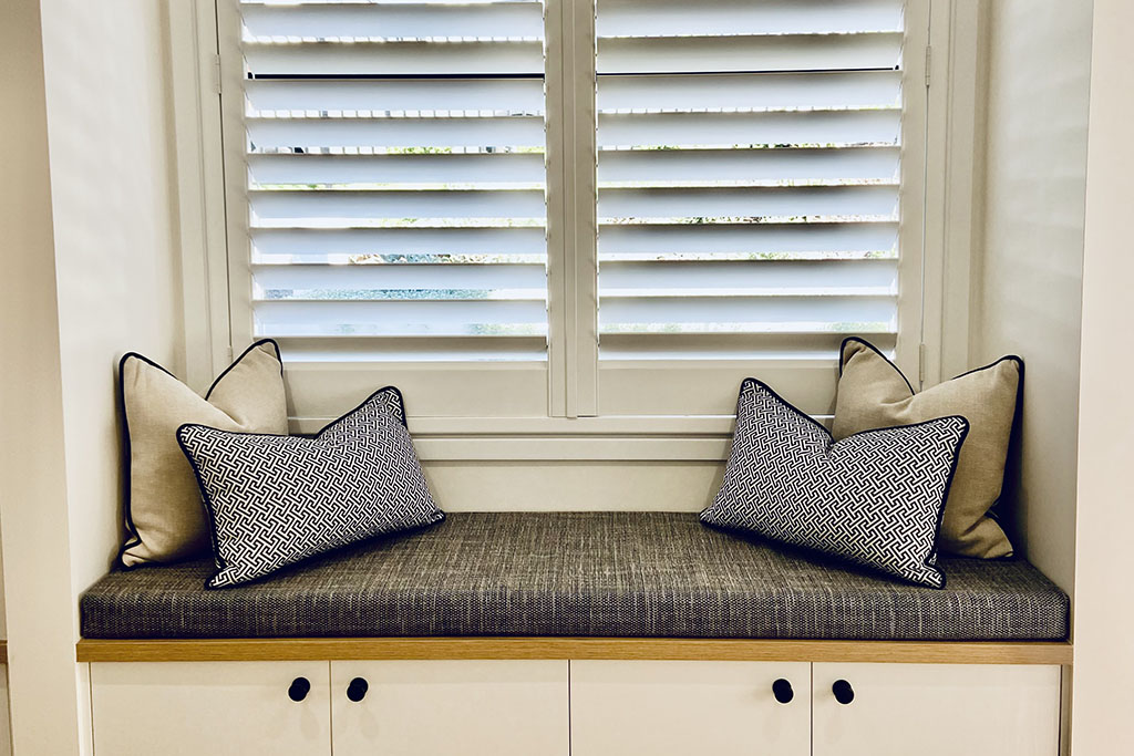 White shutters behind bench seat